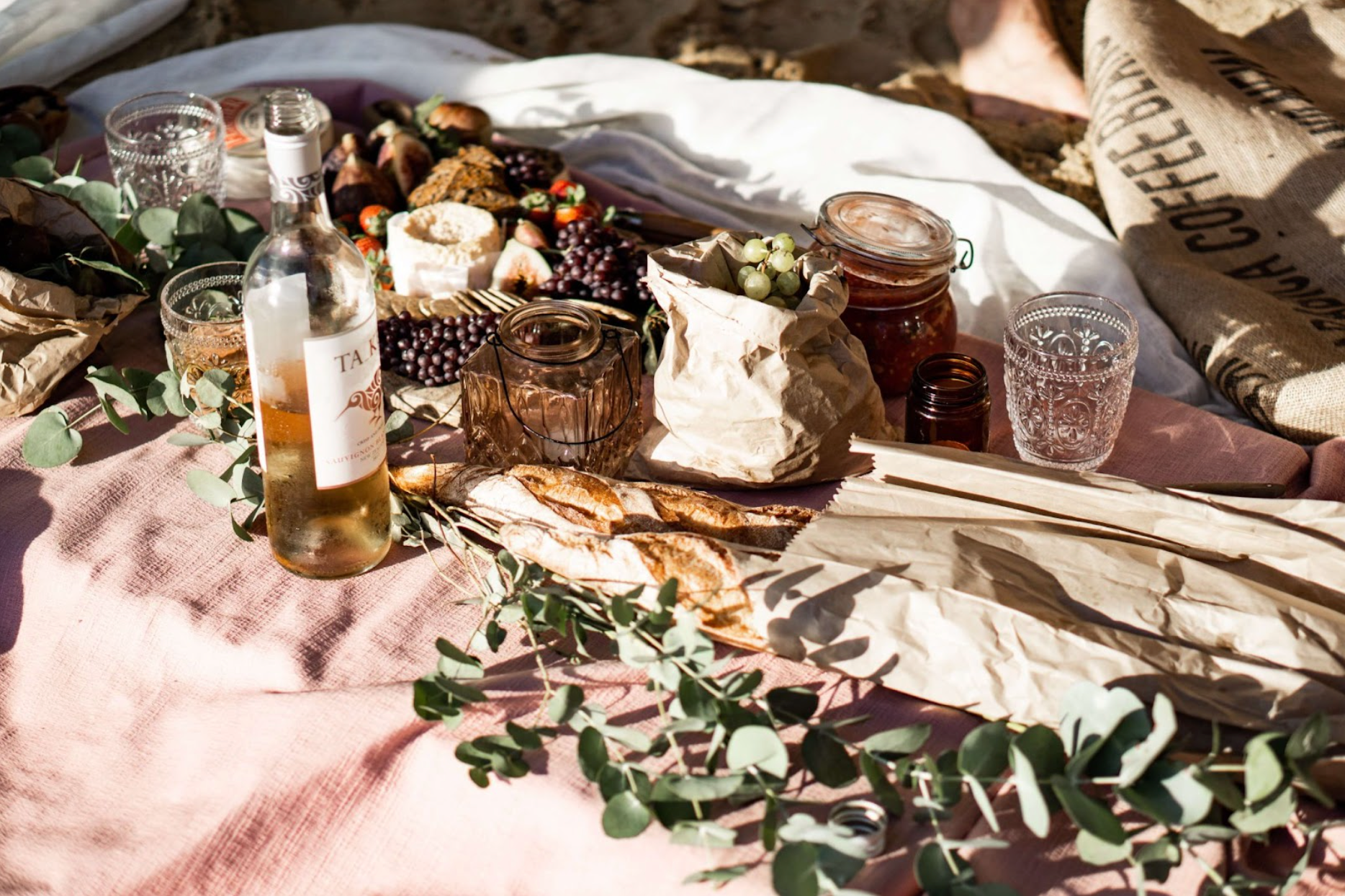 Picnic spread with wine and a blanket in the sun